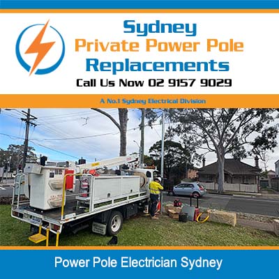 Power pole electrician in Sydney using elevated work platform for pole installation