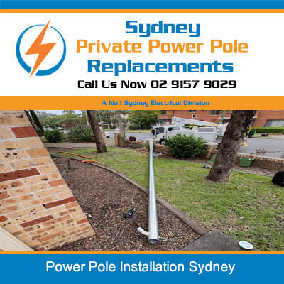 New power pole installation in residential backyard with brick paving in Sydney